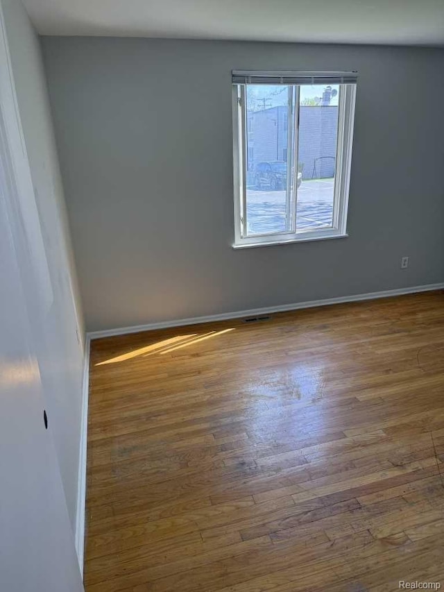 4030 W 13 Mile Rd, Lathrup Village, MI 48073 - empty room featuring wood finished floors and baseboards