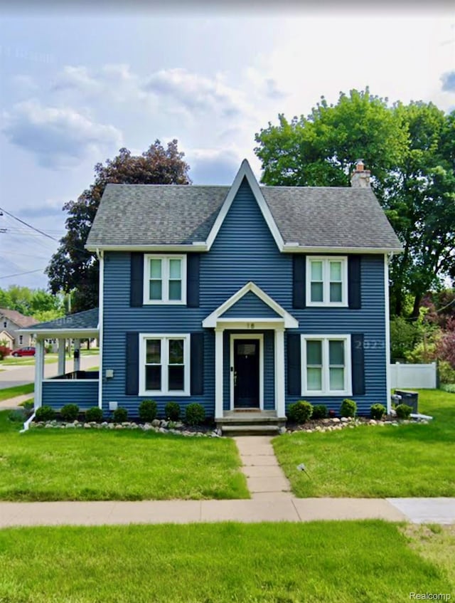 18 Park St, Oxford, MI 48371 - view of front facade featuring a chimney and roof with shingles