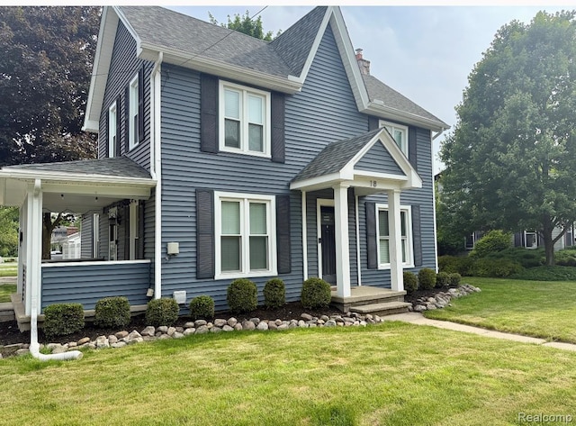 18 Park St, Oxford, MI 48371 - view of front of house featuring a front yard, a shingled roof, and a chimney