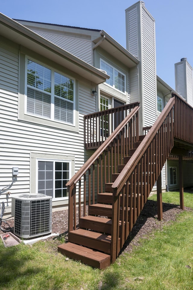 6018 Augusta Ct, Grand Blanc, MI 48439 - back of property featuring cooling unit, a deck, and stairway