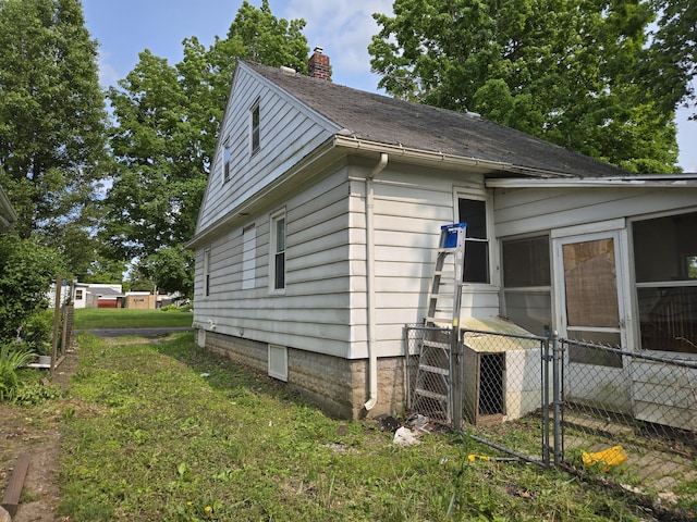 804 17th St, Jackson, MI 49203 - view of side of home with a chimney and a shingled roof