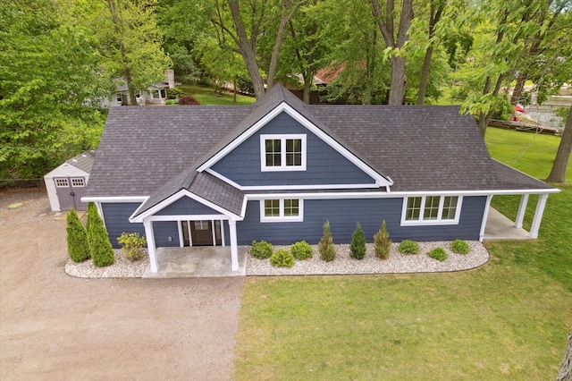 5150 Redding Dr, Pinckney, MI 48169 - view of front of house with a front lawn and a shingled roof
