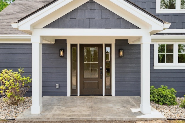 5150 Redding Dr, Pinckney, MI 48169 - property entrance with a porch and roof with shingles