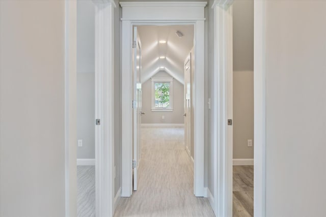 5150 Redding Dr, Pinckney, MI 48169 - hallway with lofted ceiling, baseboards, and light wood-style flooring