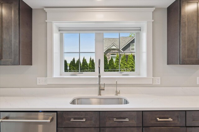5150 Redding Dr, Pinckney, MI 48169 - kitchen with stainless steel dishwasher, dark brown cabinetry, a sink, and light stone countertops
