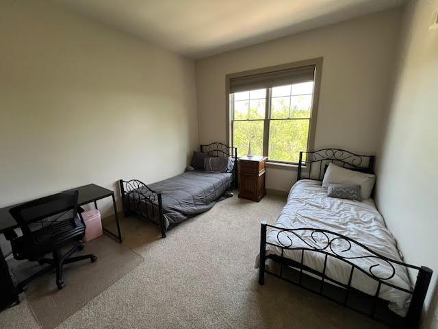600 Albert Ave Unit 524, East Lansing, MI 48823 - bedroom featuring light carpet