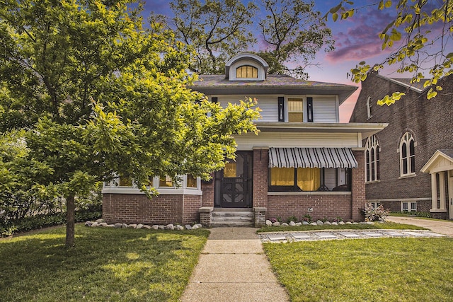 2046 Bourdon St, Muskegon, MI 49441 - traditional style home featuring a yard, entry steps, and brick siding