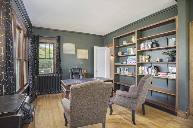 2046 Bourdon St, Muskegon, MI 49441 - home office featuring radiator heating unit, light wood finished floors, and crown molding