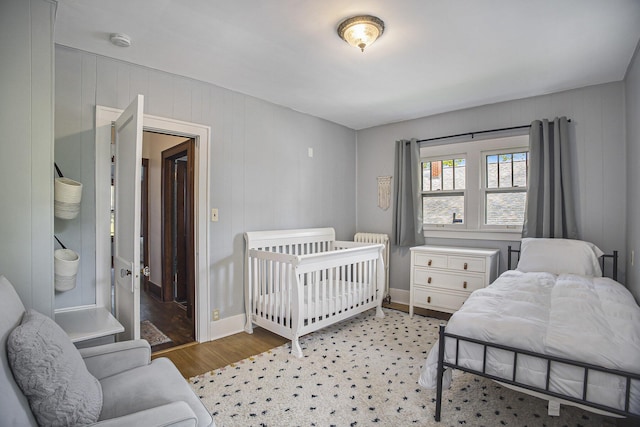 2046 Bourdon St, Muskegon, MI 49441 - bedroom with light wood-style floors and radiator