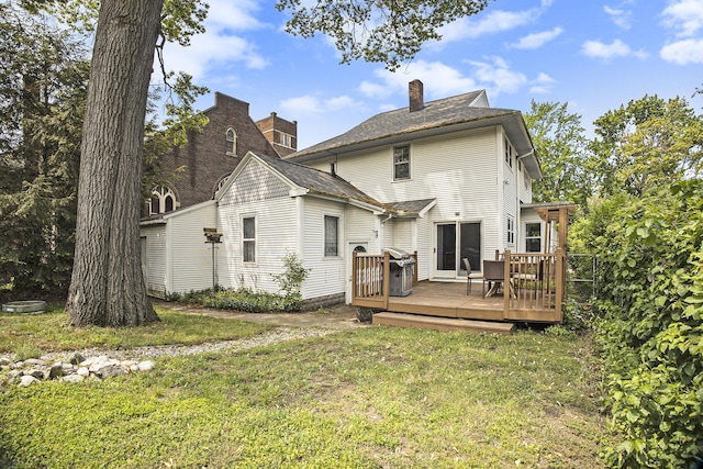 2046 Bourdon St, Muskegon, MI 49441 - back of property featuring a deck, a lawn, and a chimney