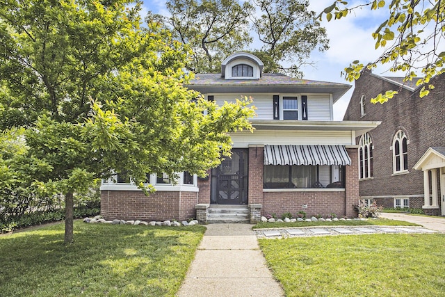 2046 Bourdon St, Muskegon, MI 49441 - american foursquare style home featuring a front lawn, entry steps, and brick siding