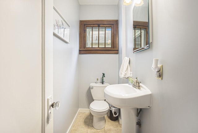 2046 Bourdon St, Muskegon, MI 49441 - half bathroom featuring toilet, baseboards, and tile patterned flooring