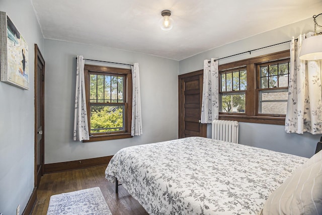 2046 Bourdon St, Muskegon, MI 49441 - bedroom with radiator, baseboards, and wood finished floors