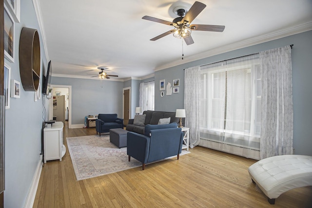 2046 Bourdon St, Muskegon, MI 49441 - living area featuring a ceiling fan, light wood-type flooring, ornamental molding, and baseboards