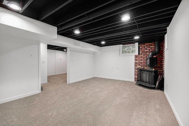 1700 Bristol Ave NW, Grand Rapids, MI 49504 - finished below grade area with a wood stove, carpet, and baseboards