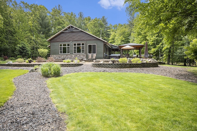 6838 E Michillinda Rd, Twin Lake, MI 49457 - back of property with a lawn, a gazebo, a patio, and stone siding