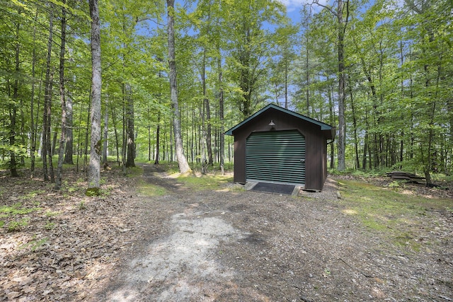 6838 E Michillinda Rd, Twin Lake, MI 49457 - garage featuring a wooded view