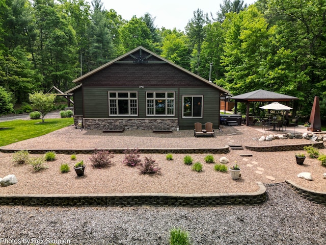 6838 E Michillinda Rd, Twin Lake, MI 49457 - back of house featuring a gazebo, a patio area, and a forest view