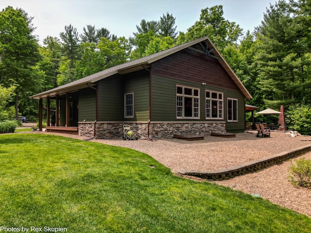 6838 E Michillinda Rd, Twin Lake, MI 49457 - rear view of house featuring a lawn and stone siding