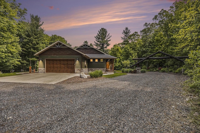 6838 E Michillinda Rd, Twin Lake, MI 49457 - view of front of home featuring gravel driveway, stone siding, and a garage