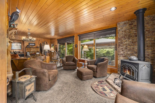 6838 E Michillinda Rd, Twin Lake, MI 49457 - living room with a wood stove, carpet, wood ceiling, a chandelier, and wood walls