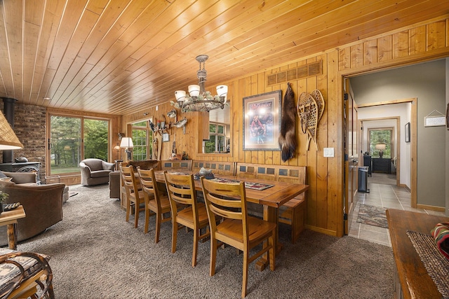 6838 E Michillinda Rd, Twin Lake, MI 49457 - dining space with a chandelier, carpet floors, wood ceiling, and wooden walls
