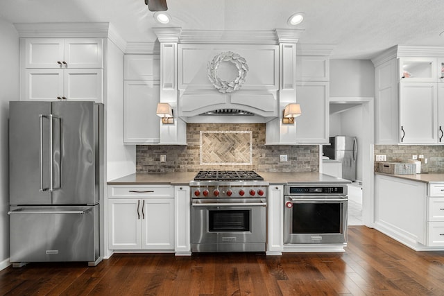 33081 Old Post Rd, Niles, MI 49120 - kitchen featuring premium appliances, white cabinets, light countertops, dark wood-style floors, and decorative backsplash