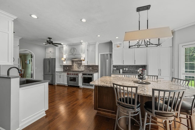 33081 Old Post Rd, Niles, MI 49120 - kitchen featuring high quality appliances, a sink, backsplash, ceiling fan, and arched walkways