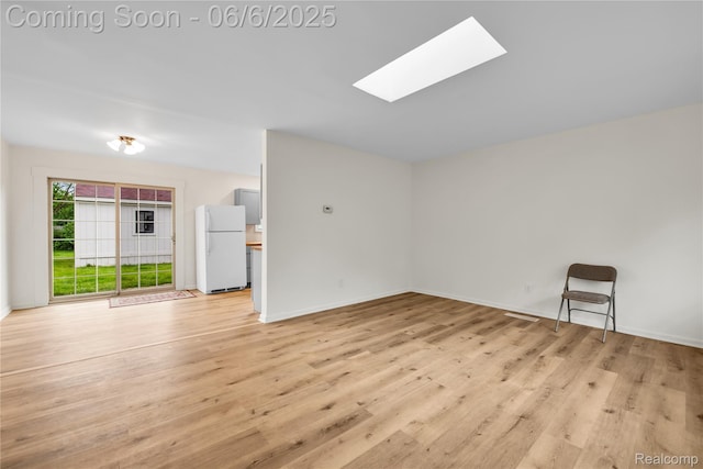 6927 Snow Apple Dr, Clarkston, MI 48346 - empty room with a skylight, light wood-type flooring, and baseboards