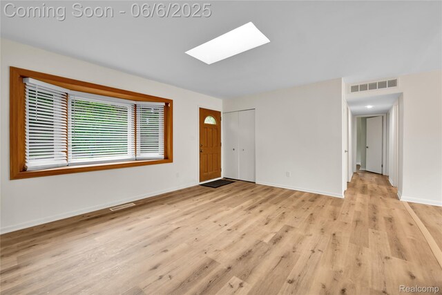 6927 Snow Apple Dr, Clarkston, MI 48346 - unfurnished room featuring a skylight, light wood finished floors, and baseboards