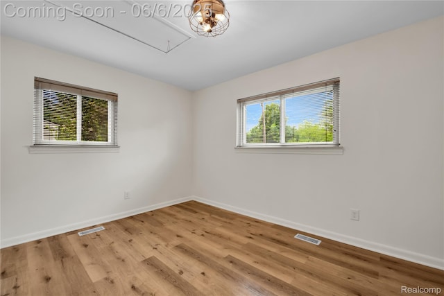 6927 Snow Apple Dr, Clarkston, MI 48346 - spare room with attic access, baseboards, and light wood-style flooring