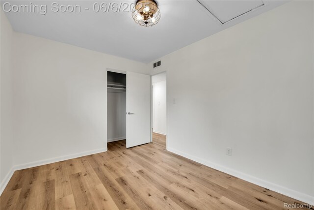 6927 Snow Apple Dr, Clarkston, MI 48346 - unfurnished bedroom featuring baseboards, wood finished floors, and a closet