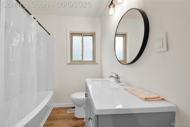 6927 Snow Apple Dr, Clarkston, MI 48346 - full bath featuring wood finished floors, toilet, vanity, baseboards, and shower / tub combo