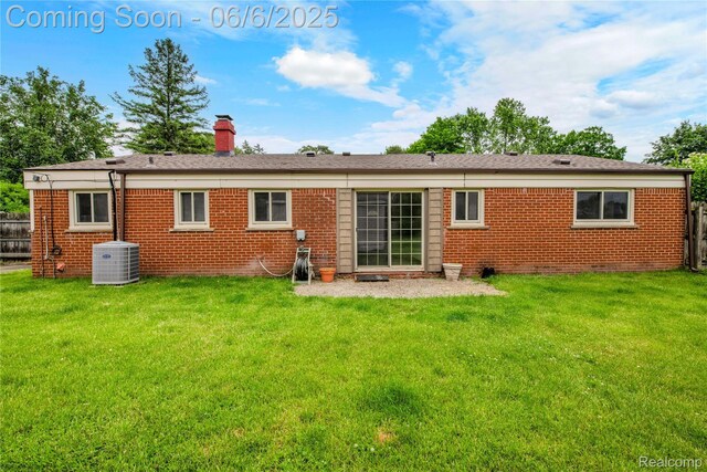 6927 Snow Apple Dr, Clarkston, MI 48346 - rear view of property featuring cooling unit, brick siding, and a chimney