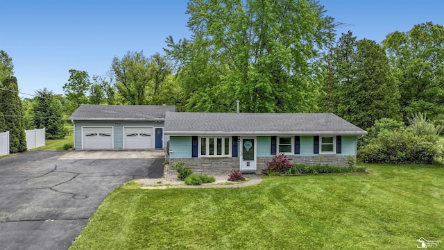 9730 Douglas Rd, Temperance, MI 48182 - view of front of house featuring driveway, an attached garage, a front yard, stone siding, and a shingled roof
