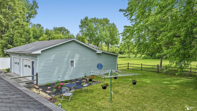 9730 Douglas Rd, Temperance, MI 48182 - view of side of home with a garage, roof with shingles, and view of wooded area
