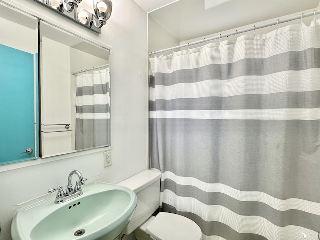 9730 Douglas Rd, Temperance, MI 48182 - bathroom featuring a sink, toilet, and a shower with curtain