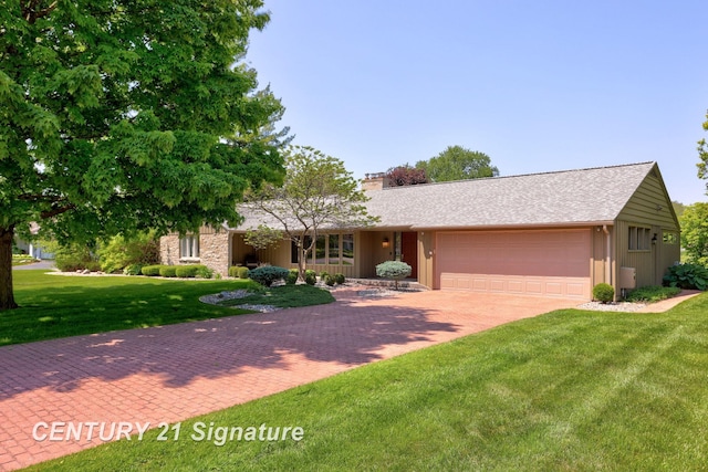 12 W Corral Dr, Saginaw, MI 48638 - ranch-style house featuring a garage, a chimney, decorative driveway, and a front lawn