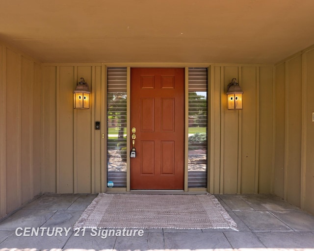 12 W Corral Dr, Saginaw, MI 48638 - doorway to property featuring board and batten siding