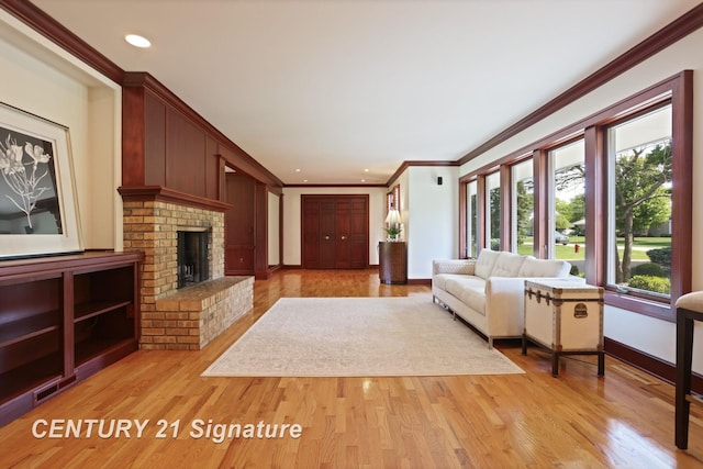 12 W Corral Dr, Saginaw, MI 48638 - living room with crown molding, light wood-type flooring, baseboards, a brick fireplace, and recessed lighting