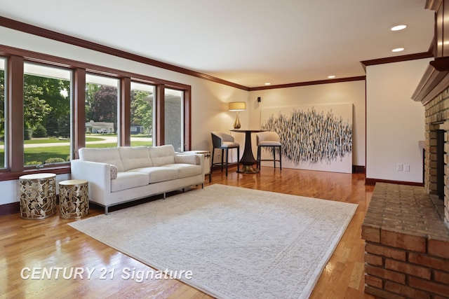 12 W Corral Dr, Saginaw, MI 48638 - living area with a fireplace, ornamental molding, baseboards, wood finished floors, and recessed lighting