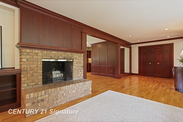 12 W Corral Dr, Saginaw, MI 48638 - unfurnished living room with crown molding, wood finished floors, recessed lighting, and a brick fireplace