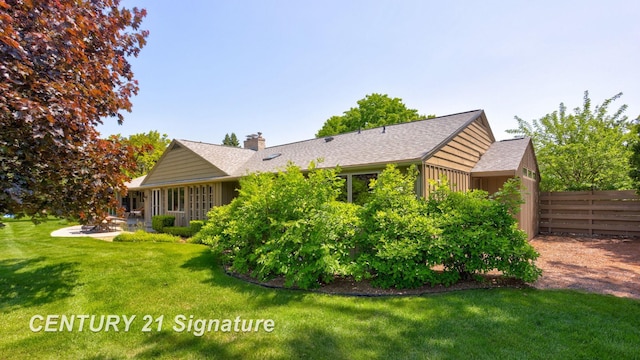 12 W Corral Dr, Saginaw, MI 48638 - back of property featuring a patio, a chimney, and a shingled roof