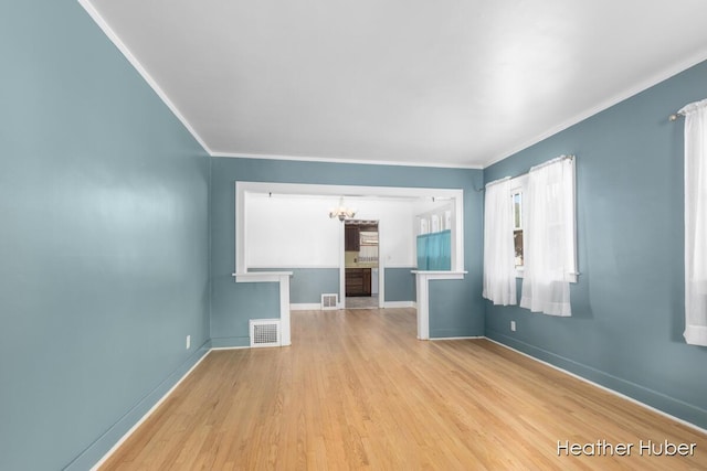 851 Graceland St NE, Grand Rapids, MI 49505 - empty room with a chandelier, wood finished floors, crown molding, and baseboards
