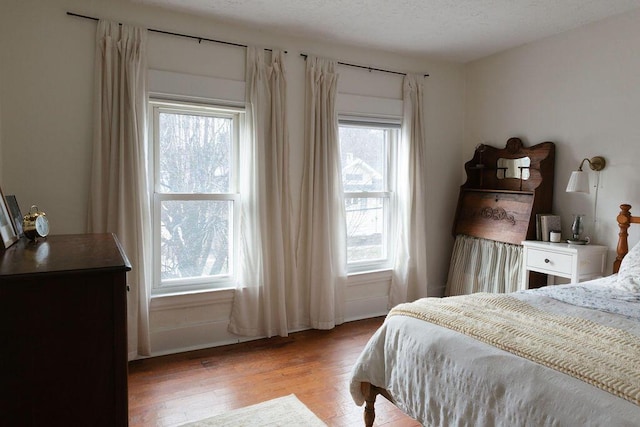 1550 Pine Ave NW, Grand Rapids, MI 49504 - bedroom featuring wood finished floors, multiple windows, and baseboards