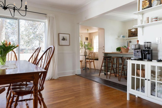 1550 Pine Ave NW, Grand Rapids, MI 49504 - dining area with a chandelier and wood finished floors