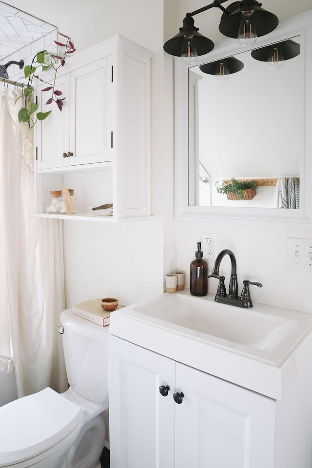 1550 Pine Ave NW, Grand Rapids, MI 49504 - bathroom with toilet, vanity, and ceiling fan
