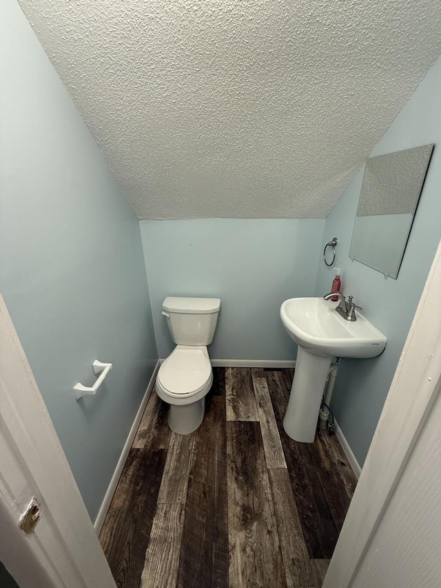 106 S Berkley St, Kalamazoo, MI 49006 - half bathroom with a textured ceiling, toilet, wood finished floors, baseboards, and a sink