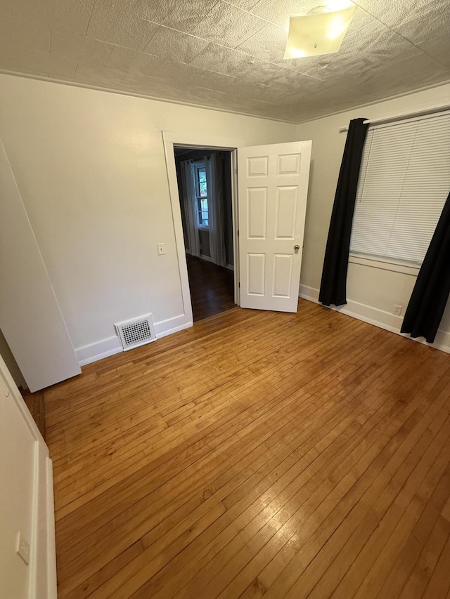 106 S Berkley St, Kalamazoo, MI 49006 - unfurnished bedroom with hardwood / wood-style flooring and baseboards