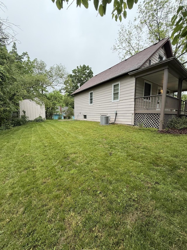 106 S Berkley St, Kalamazoo, MI 49006 - view of grassy yard featuring central AC unit and covered porch
